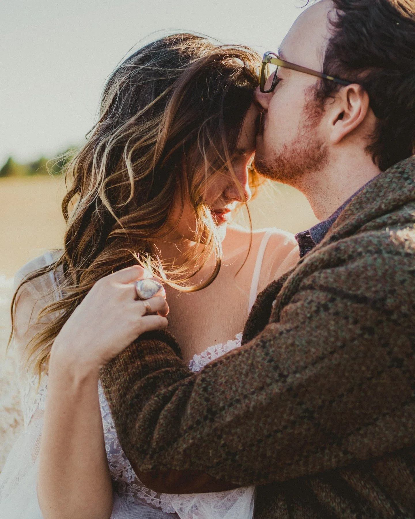 When that late afternoon sun hits just right on your elopement wedding shoot 😍
.
.
.
.
.
[Image Description: A white woman with long highlighted brown hair wearing a boho-style wedding dress is leaning her forehead into a kiss from her husband, a wh