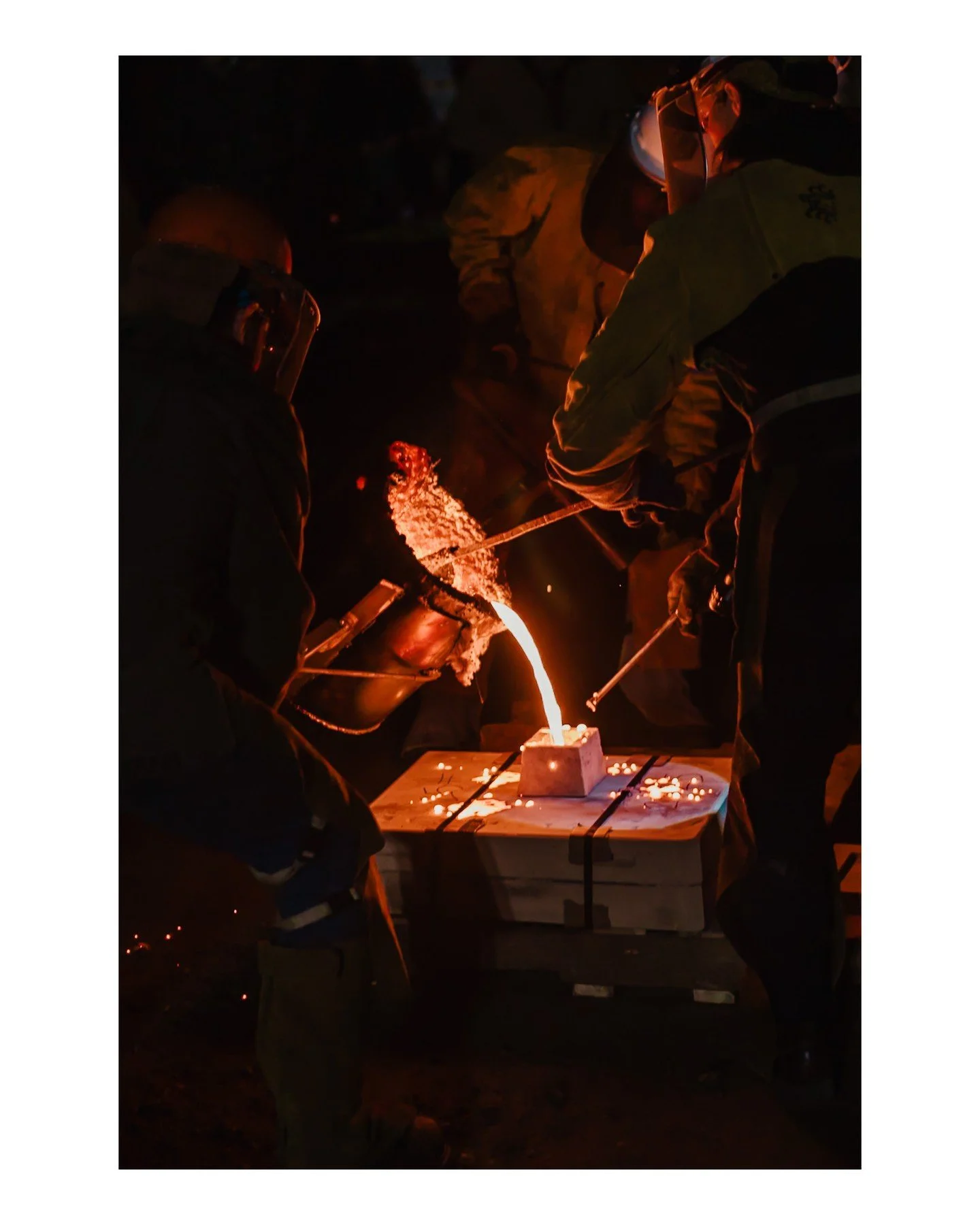 In case you missed it, the Pour'N Yer Heart Out (PYHO) photos are ready! Head to the #linkinio to see the molten iron glory! 
.
.
.
.
.
[Image Description: A close-up image of iron pourers doing an iron pour at night, pouring iron into a mould.]