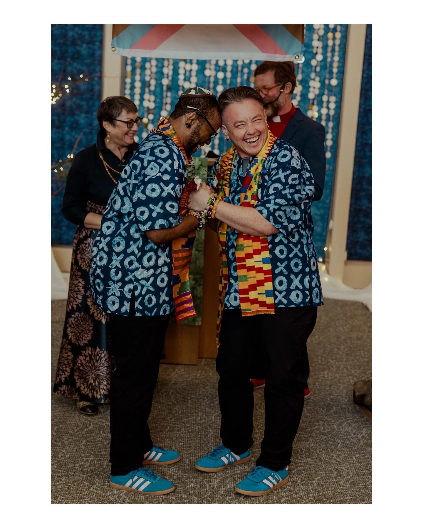 I love this candid moment from Stormy + Meier's beautiful multicultural and multi-faith wedding day 😍 We love working with couples who can laugh together! 
.
.
.
.
.
[Image Description: A Black trans man wearing an African shirt and black pants, alo