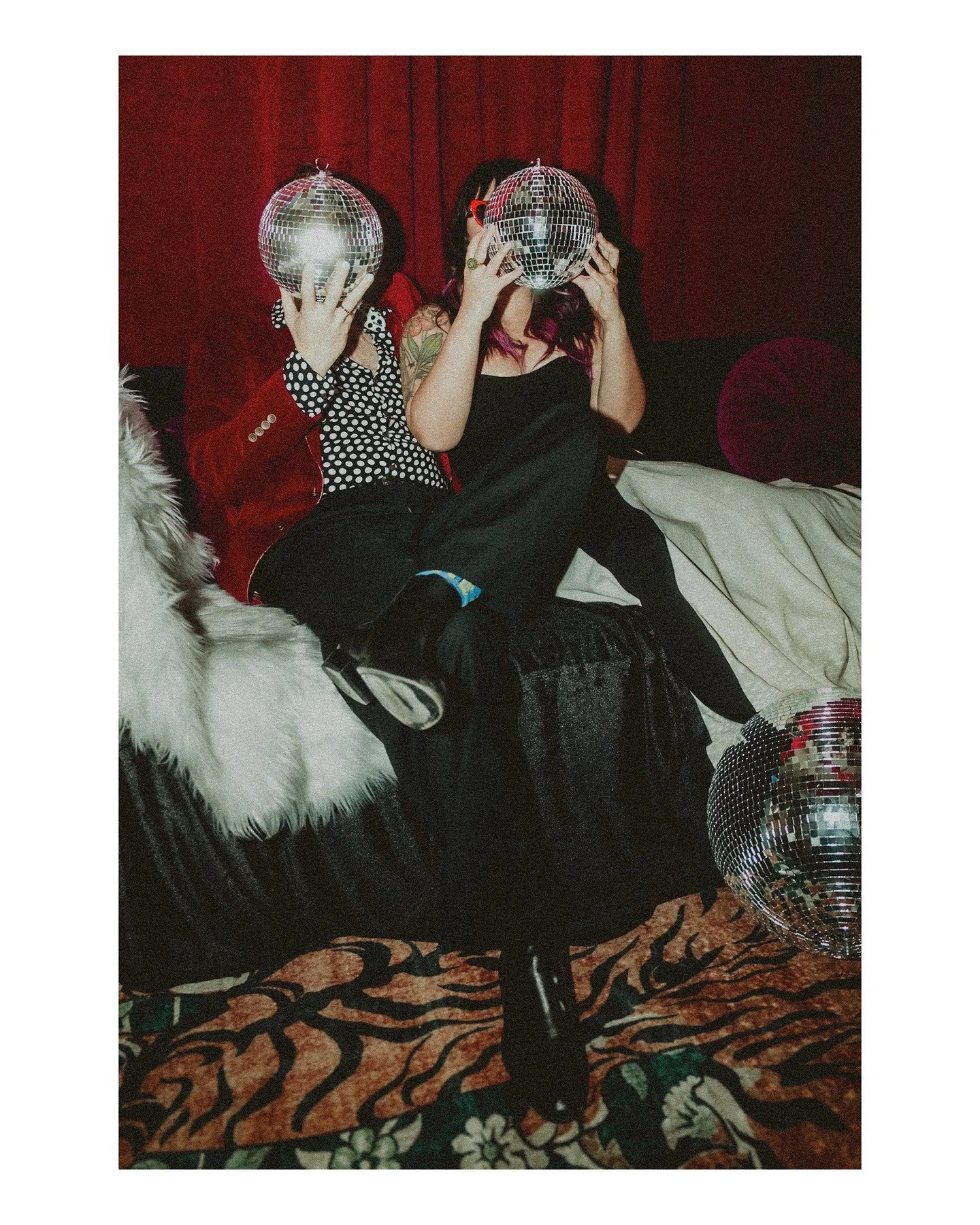 You're not a traditional couple, why the heckfire should you have traditional photos? &macr;\_(ツ)_/&macr; 🪩❤️
.
.
.
.
.
.
[Image Description: A white man wearing a deep red velvet jacket with black &amp; white polka dot dress shirt &amp; black pants