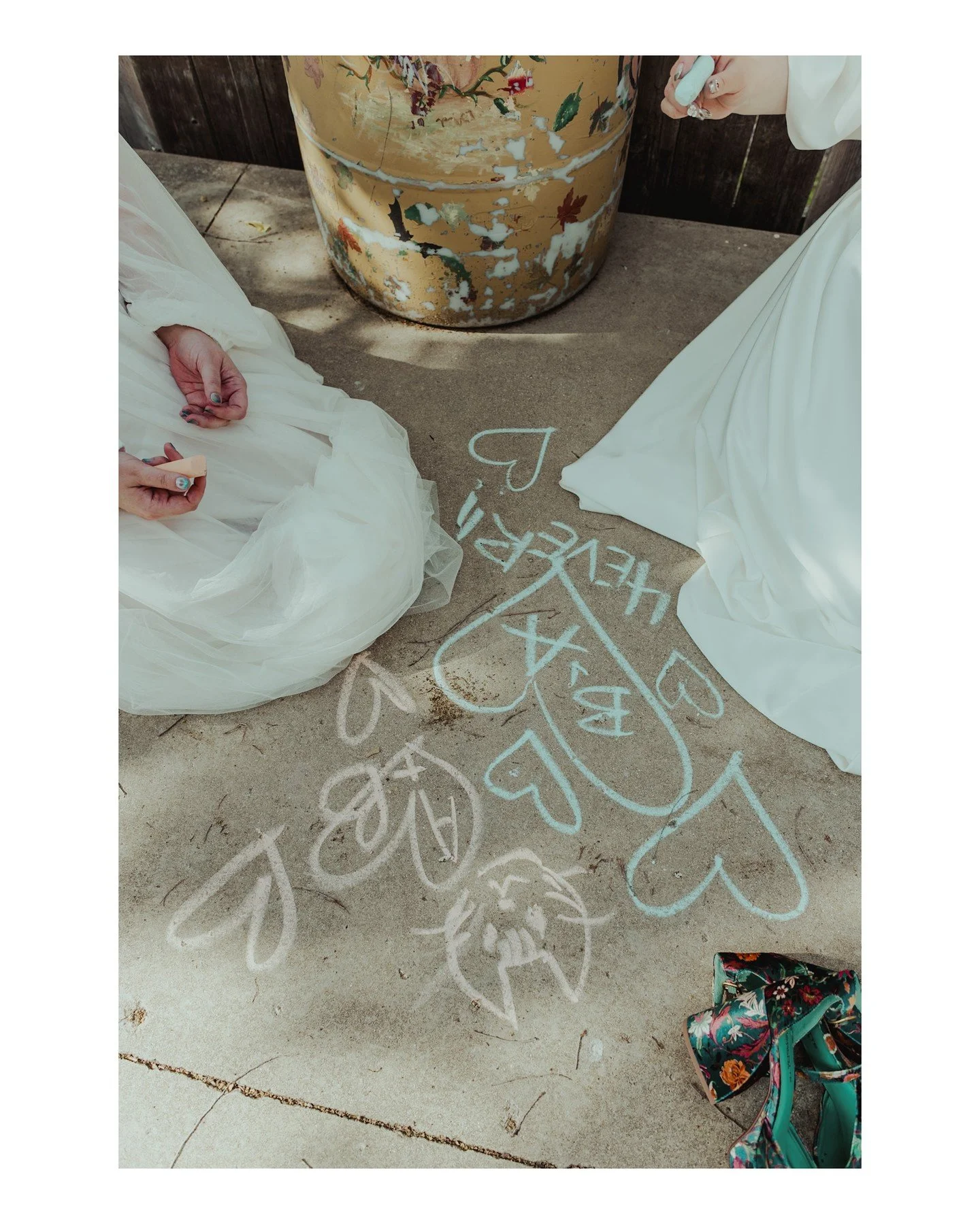 If you've been waiting for a sign, here it is: Write love notes to your partner, your spouse, your bestie, and everyone you've ever loved. Make it weird 💖
.
.
.
.
.
.
[Image Description: A close-up image of two brides kneeling on a concrete slab wit