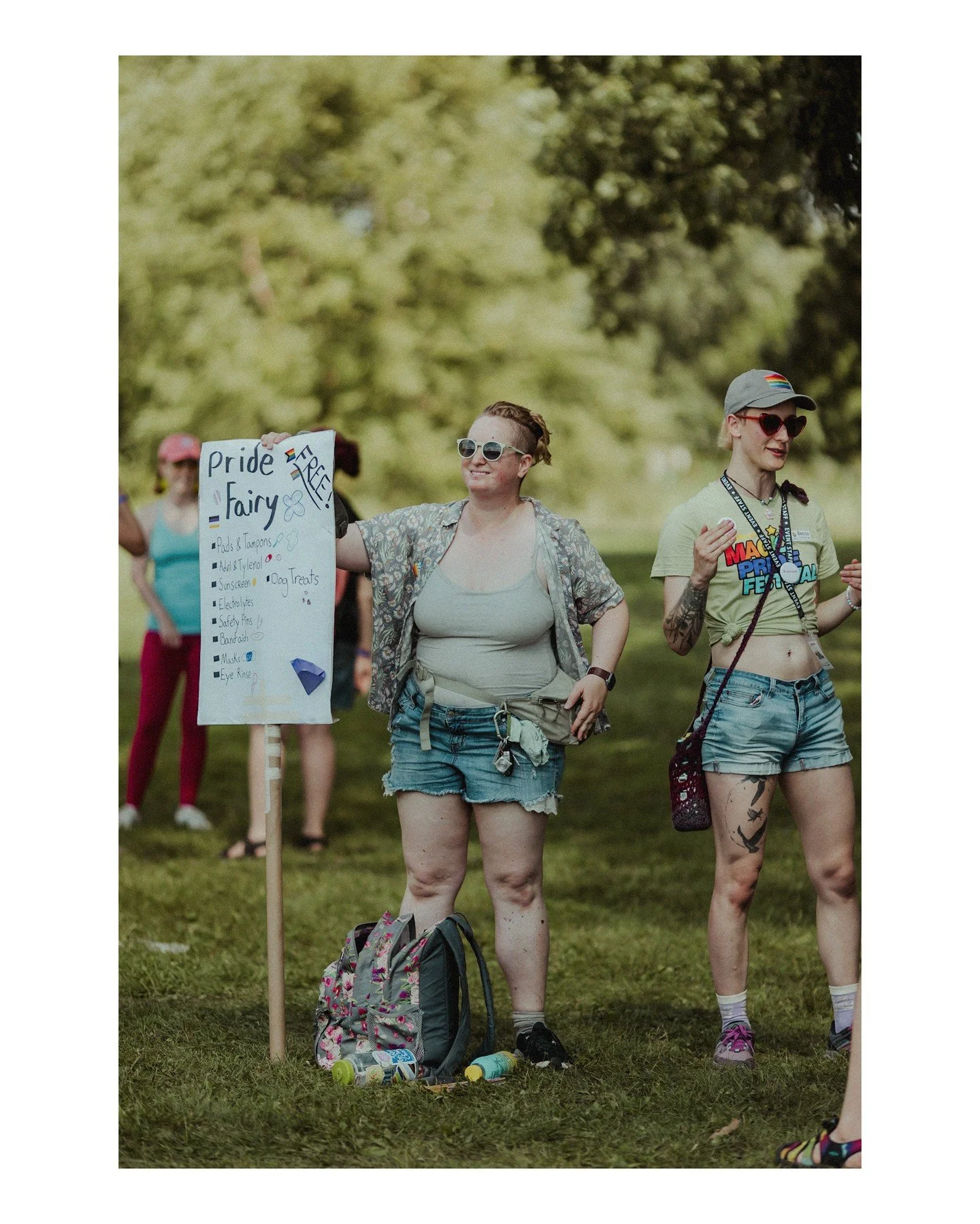All hail these heroes at Magic Pride Fest 🤩💜🏳️&zwj;⚧️🏳️&zwj;🌈
.
.
.
.
.
.
[Image Description: A picture of two white people at Pride Fest wearing cutoff denim shorts and tops, and one is holding a sign that says "Pride Fairy" that then