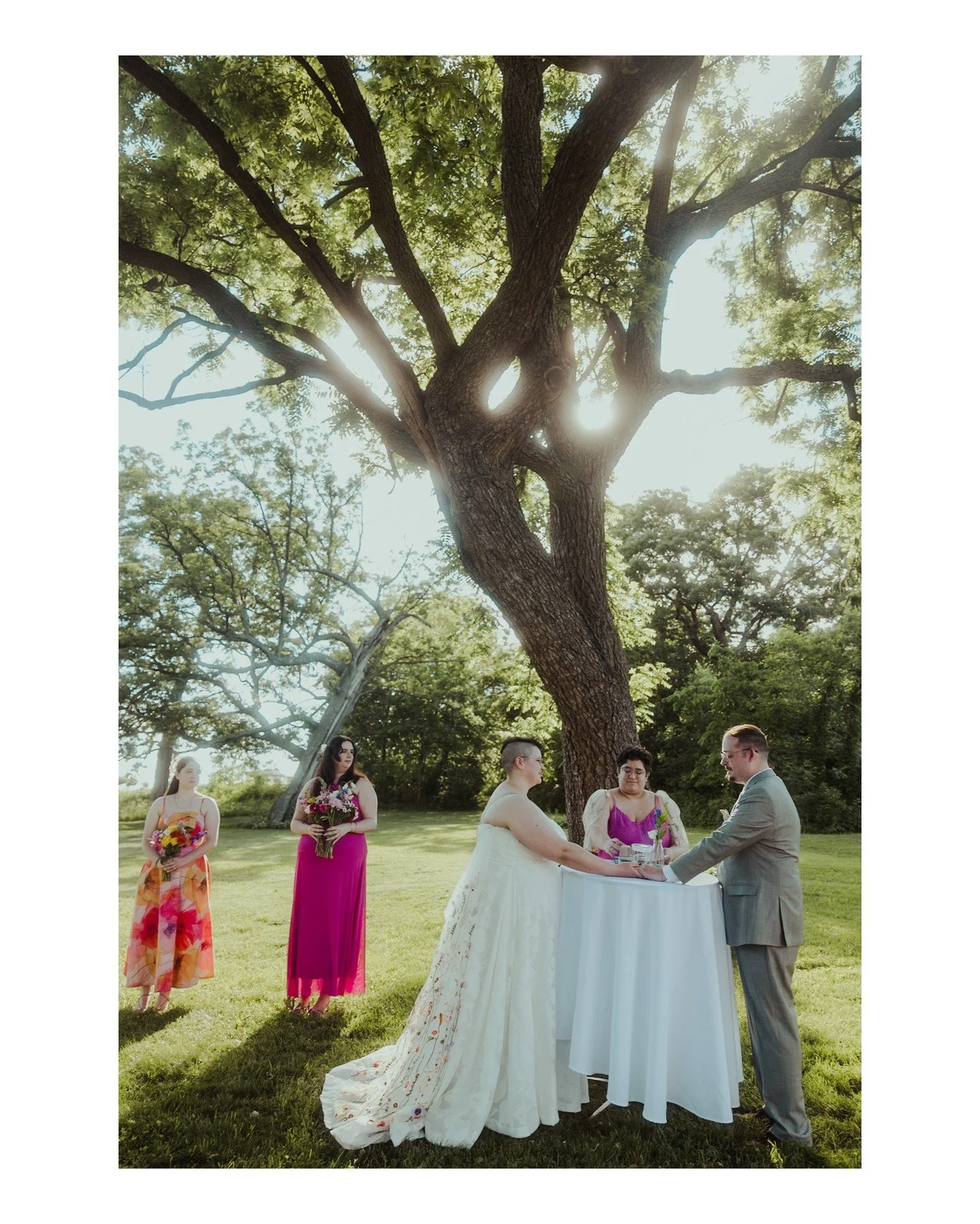Morgan (they/them) + Justin (they/them) had such a beautiful outdoor, COVID-conscious ceremony at Cave of the Mounds. This picture captures the dreamy magic of their ceremony, and check out Morgan's floral embroidered wedding cape 😍 If you're also h