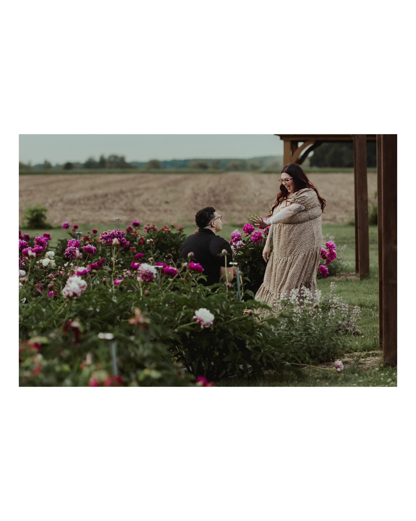 This surprise proposal at @ovanspeonyfarm was sooooooo pretty (I mean seriously, the setting was fantastic) and most importantly of all..... She said yes! 
.
.
.
.
.
.
[Image Description: A Black woman with short black curly hair wearing a black shir
