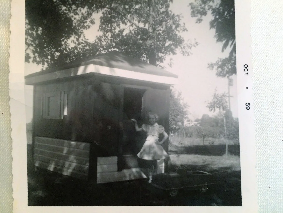 Linda at eight years old in front of the playhouse Mom built me