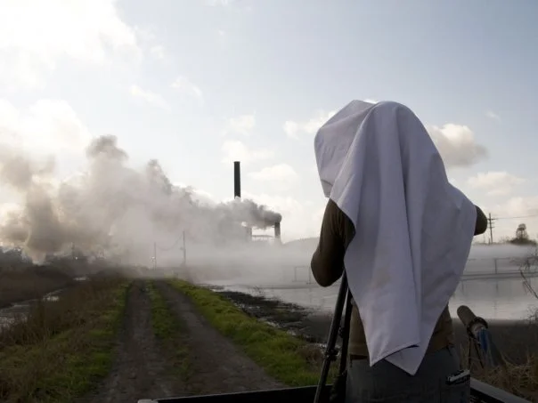 Brandon Schulman at work, shooting a sugar cane-processing plant in Atchafalaya, Louisiana, 2009