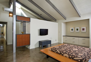 Painting the rafters in a contrasting color turns the exposed ceiling into one of the house's central design elements. PHOTO BY: HAL LUM