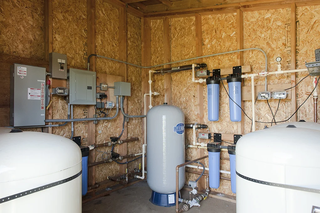 Potable Water Purification System, harvested rainwater is cleaned and purified through a multistep treatment system to provide potable water demands for the property.