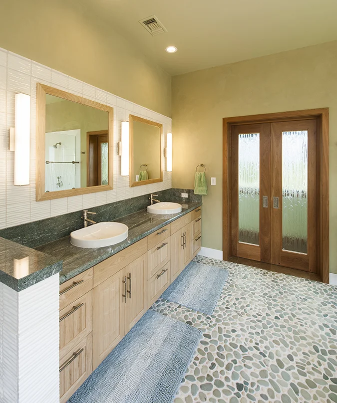 Natural Materials include: Local FSC wood for cabinets, pebble flooring, natural clay plaster on walls.
