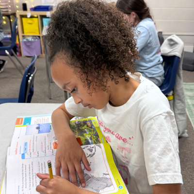 GCS approved girl workbook at desk.png