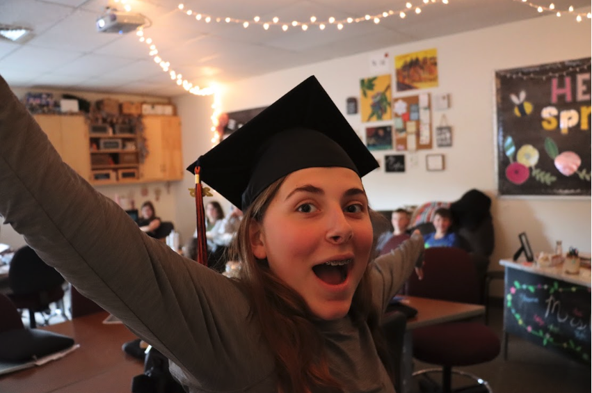 middle school graduate with cap smiling