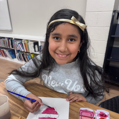 smiling student painting