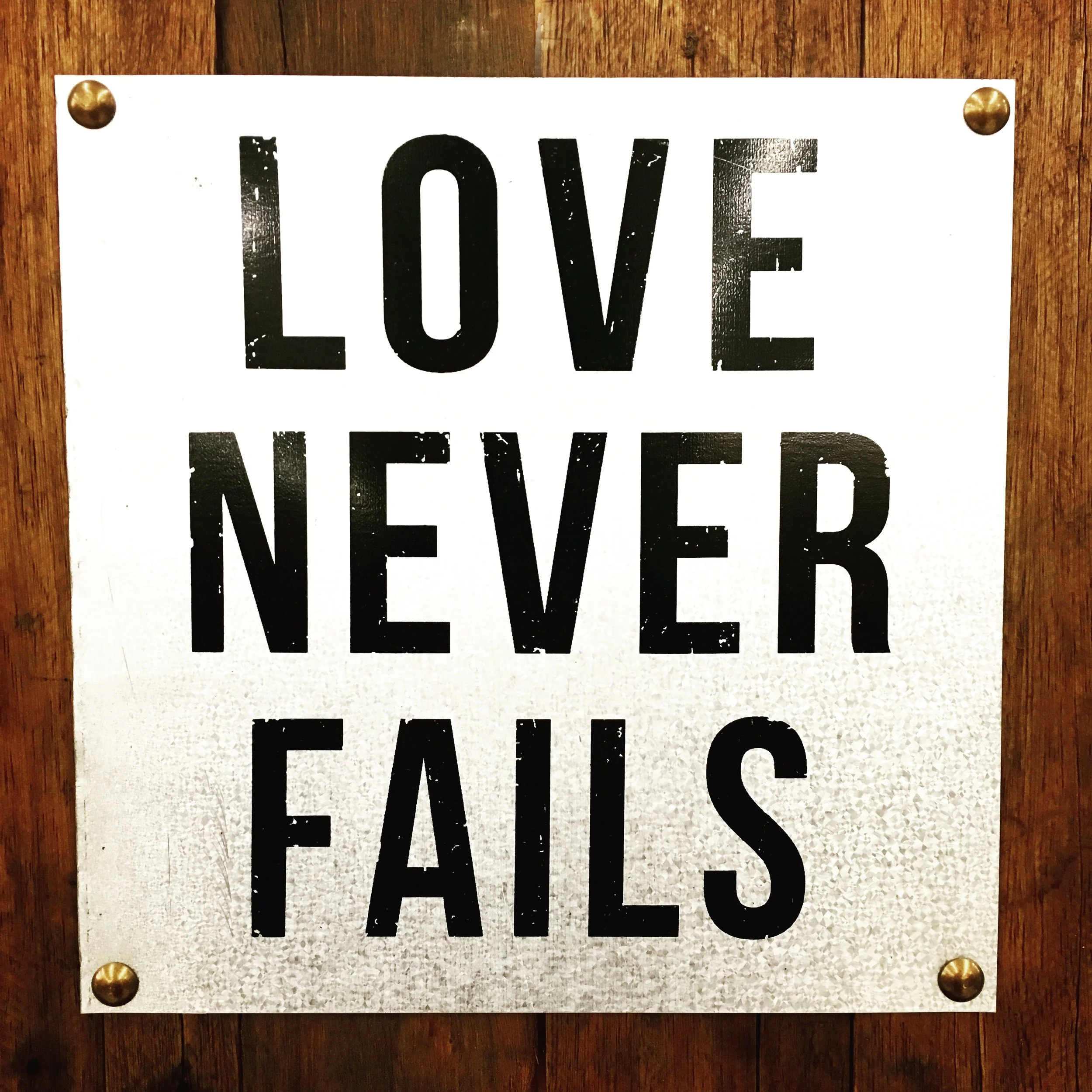      

 
   Love never fails. Except when it does.  Don't get me wrong, I love Hobby Lobby and all the little signs they sell. I typically want one of everything when I walk through the store. But this particular metal sign grabbed my attention. The 