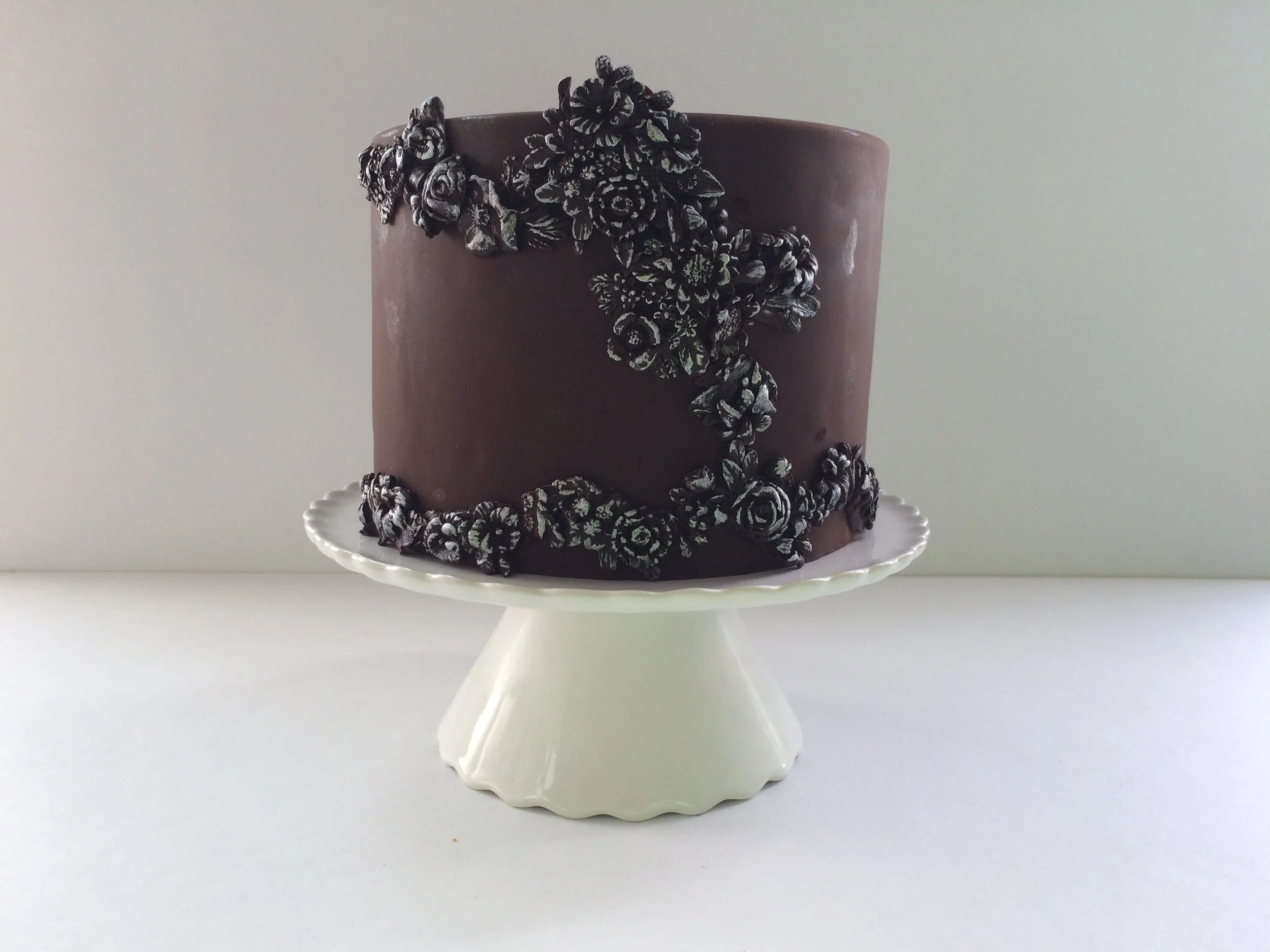 Chocolate fondant cake with chocolate bas relief decorations