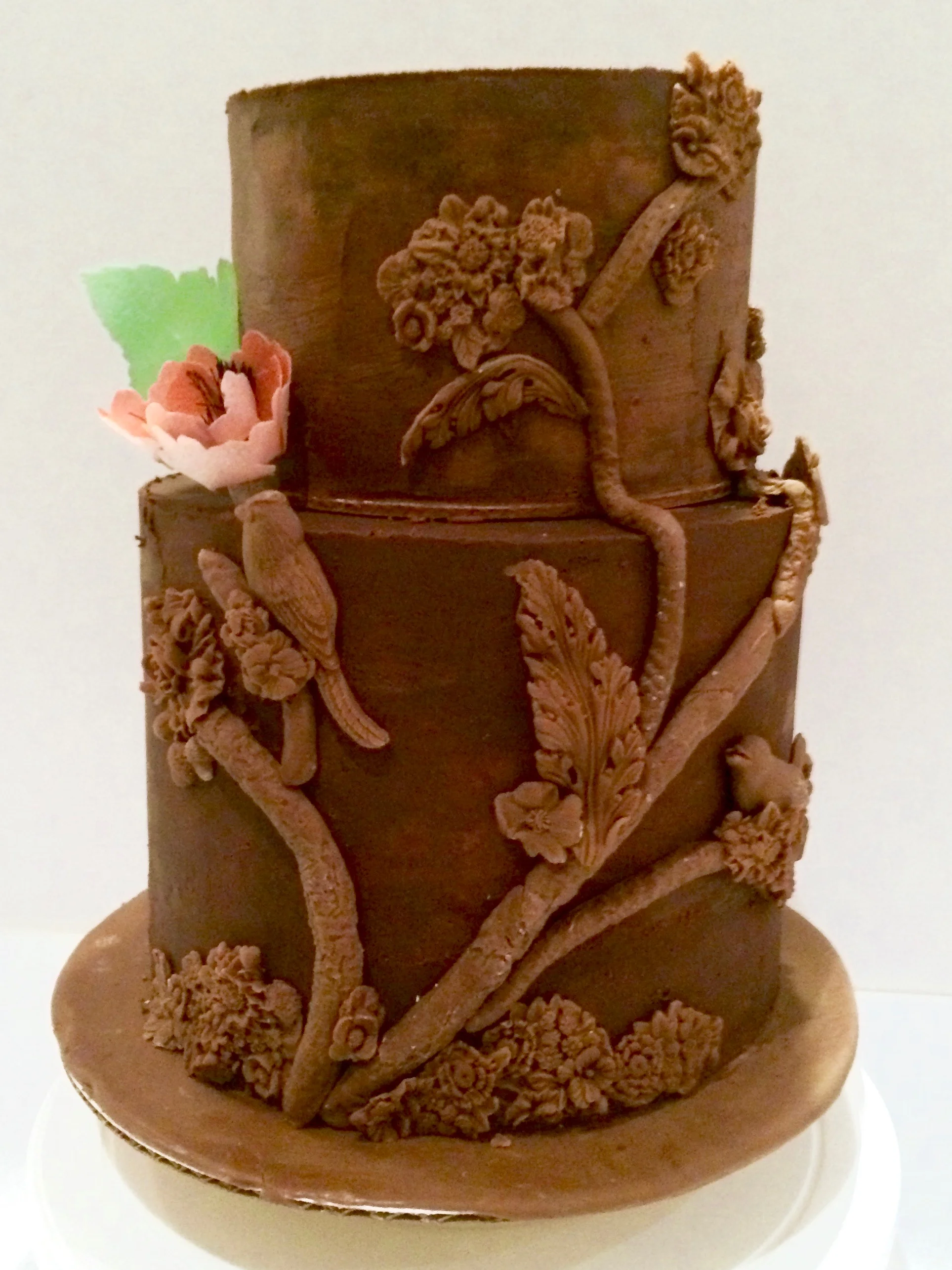 Chocolate ganache cake with chocolate bas relief decorations