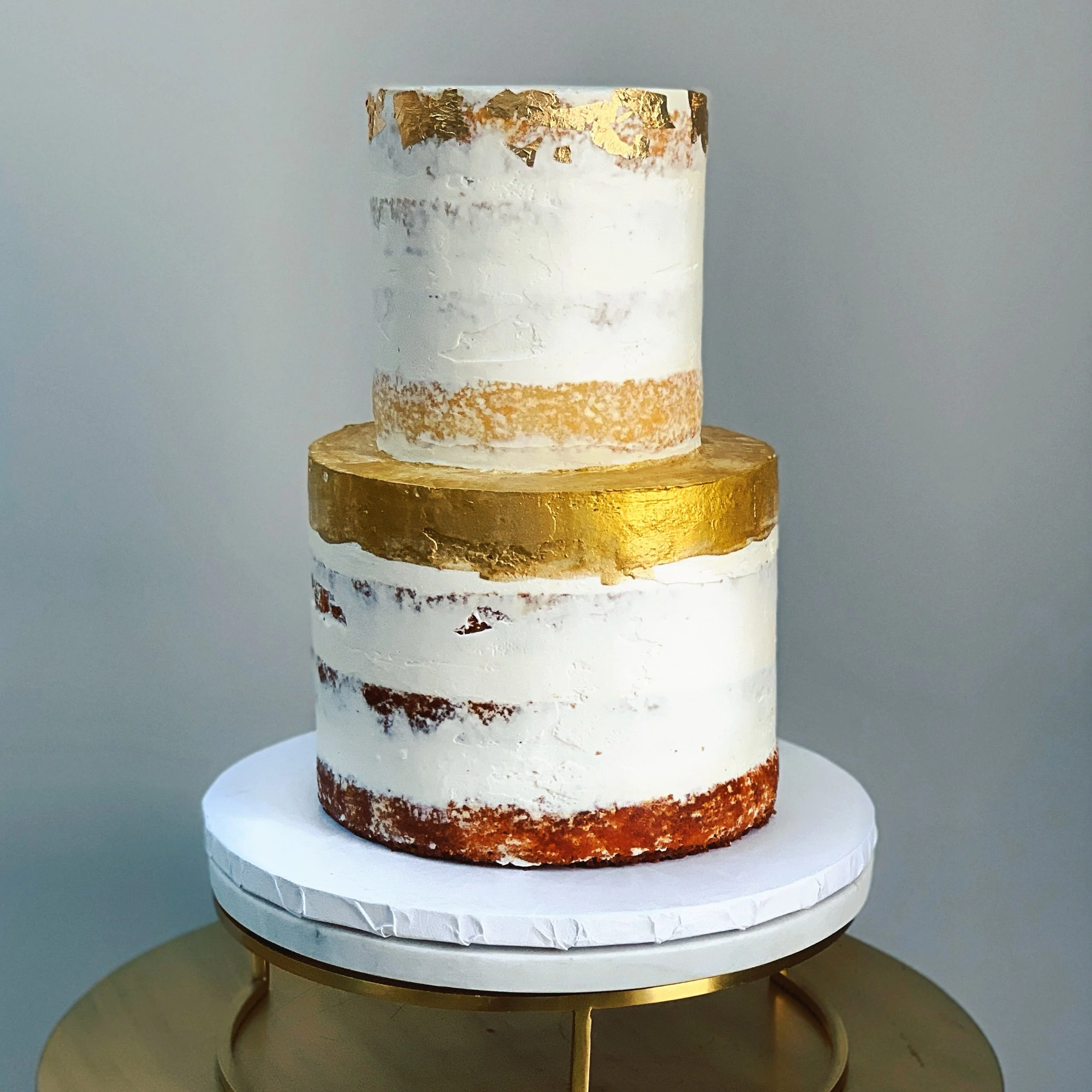 Semi naked buttercream cake with brushed edible gold