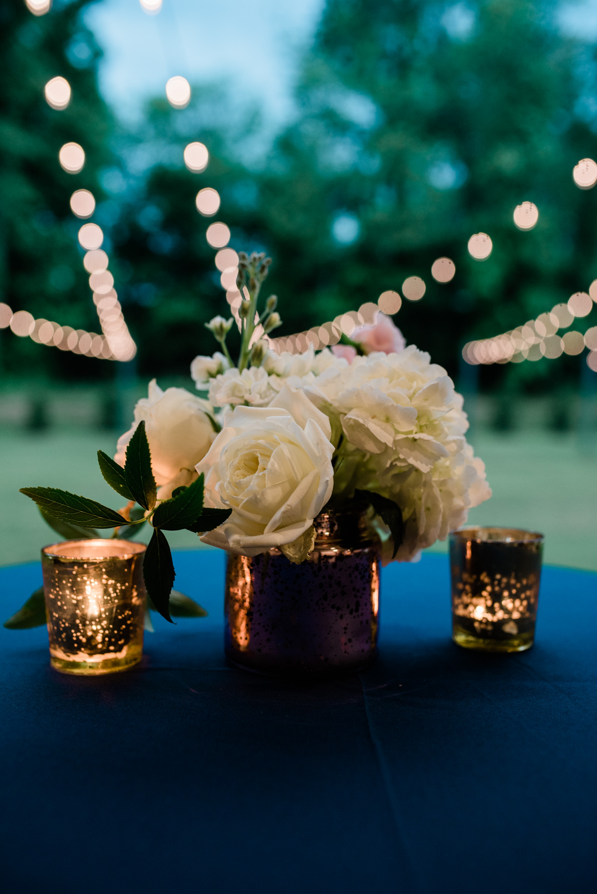 Wedding Floral arrangement with mercury glass candles.jpg