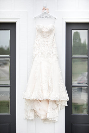 Wedding Gown against white walls and black doors