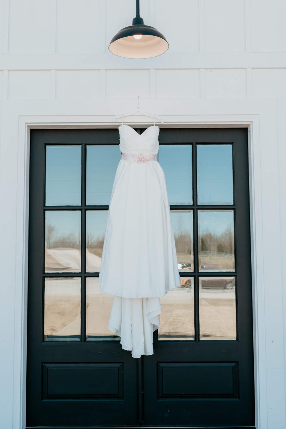 wedding dress in front of black doors .jpg