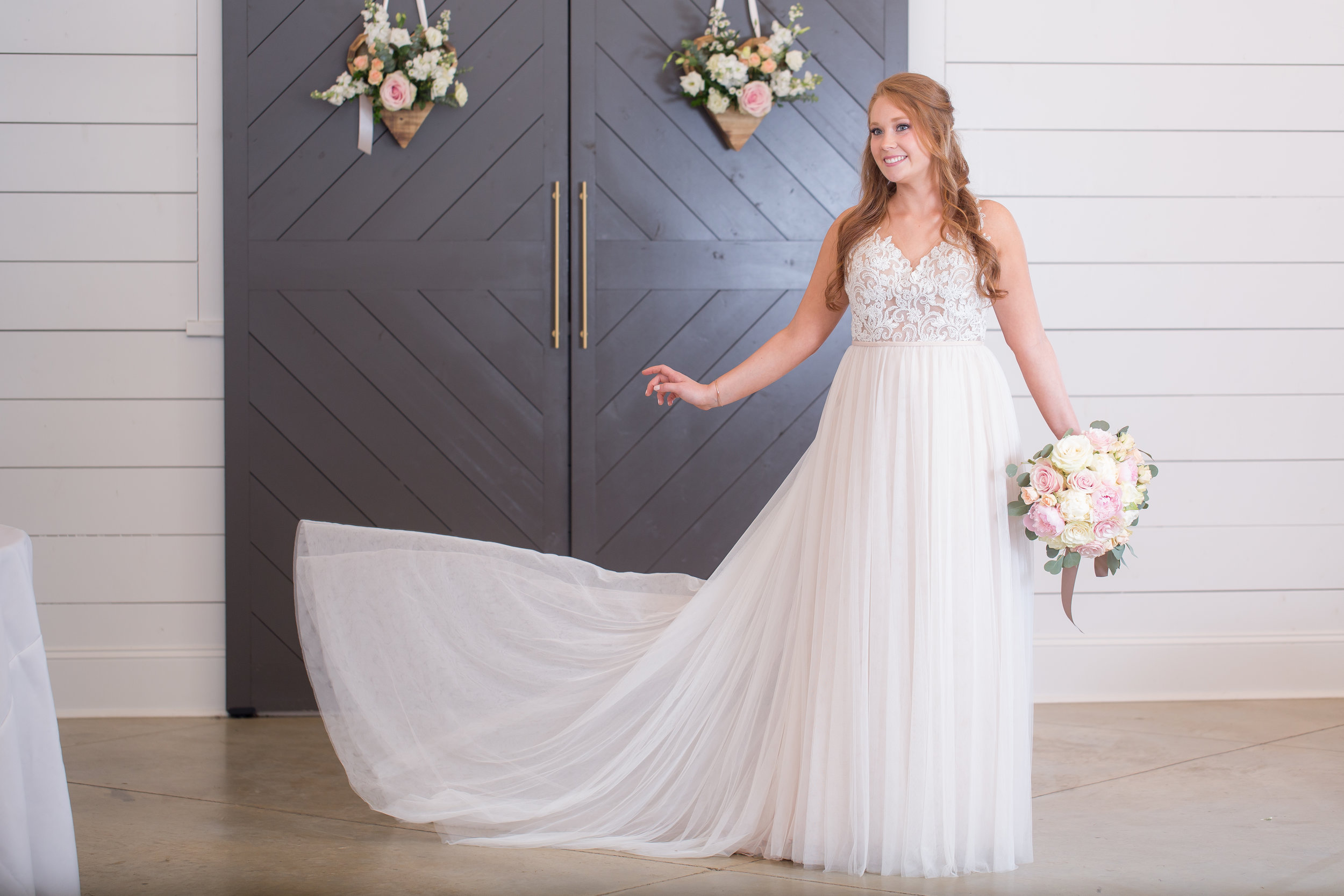 bride infront of grey barn doors .JPG