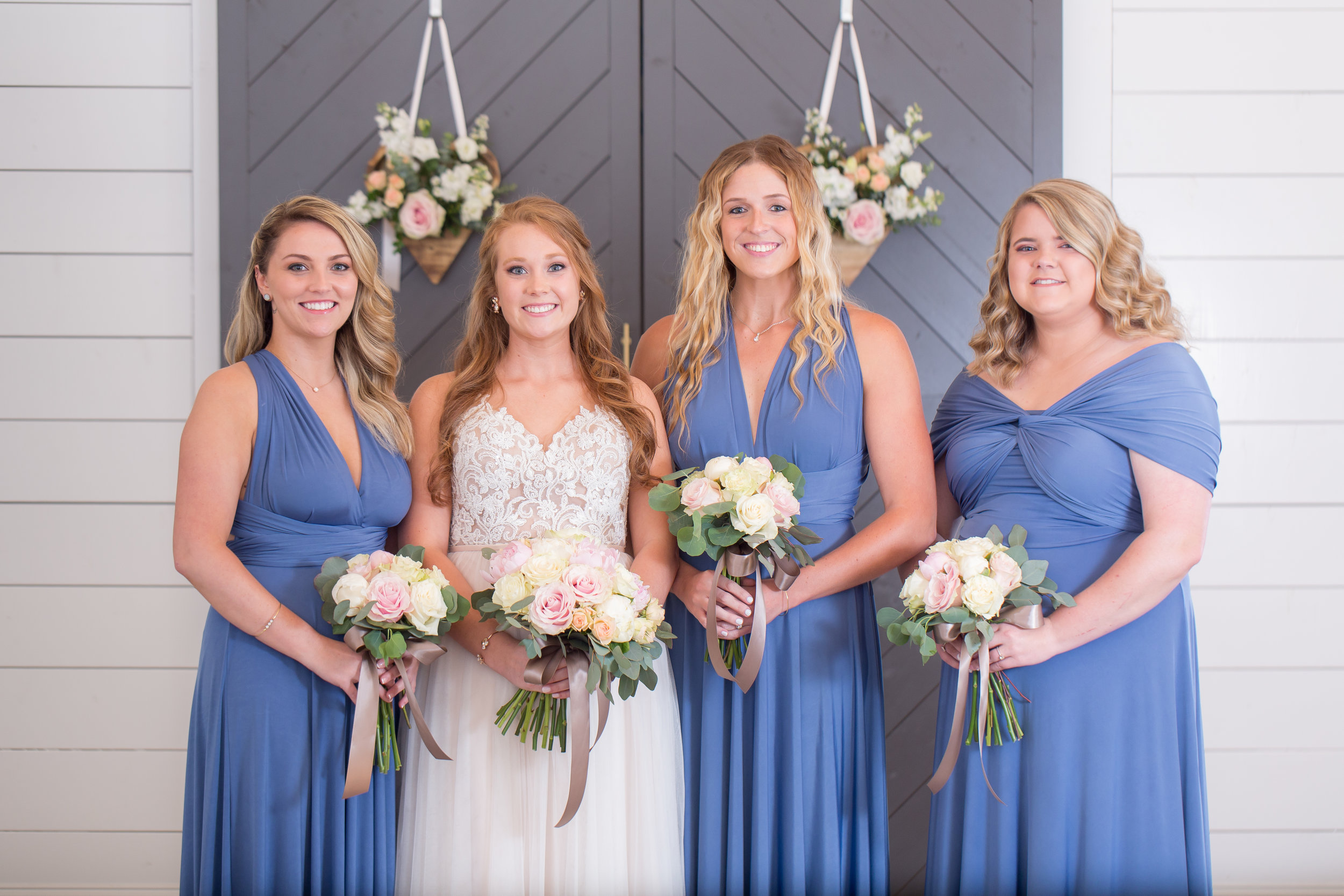 bridesmaids photo infront of grey barn doors .JPG