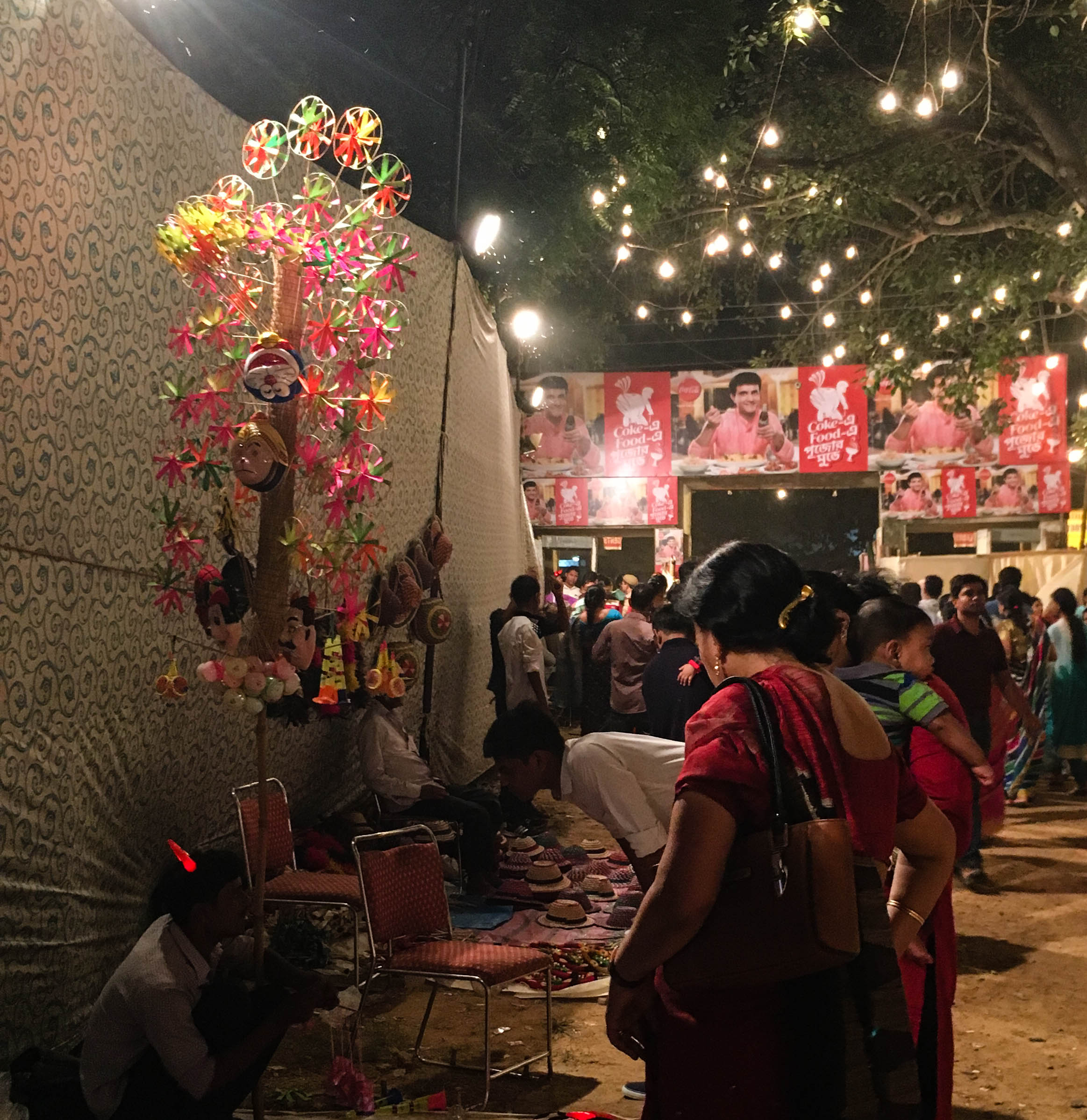 The goddess has vanquished Mahishasur, but the red-horned fan seller poses a little problem: to buy or not to buy yet another fan?