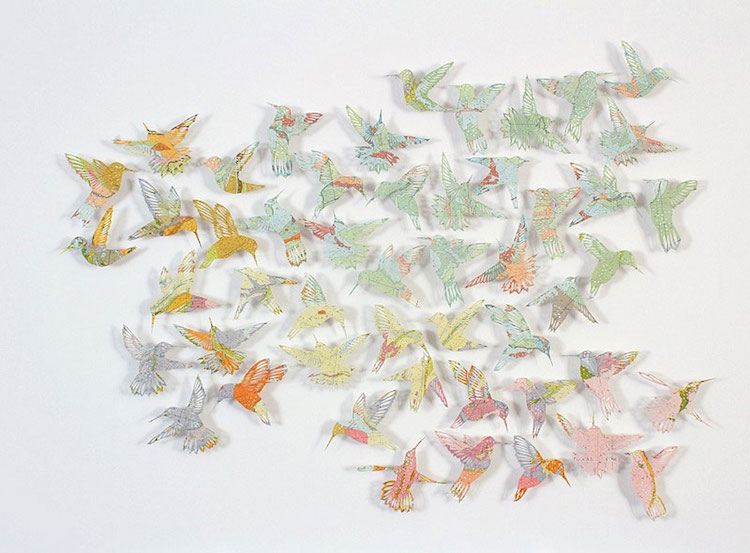 Paper Birds, an installation made out of cut-out atlases, by Claire Brewster. Sourced from mymodernmet.com.