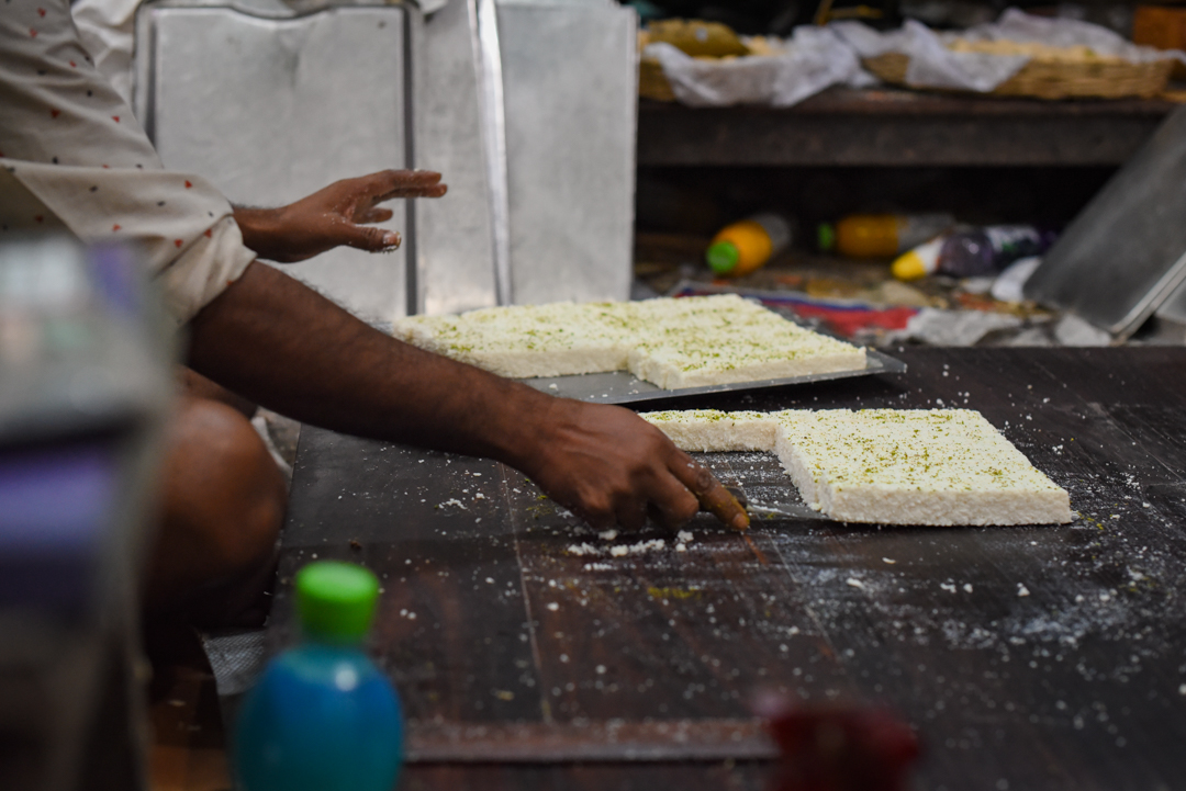 The art of balancing rows of soft sandesh on a knife.