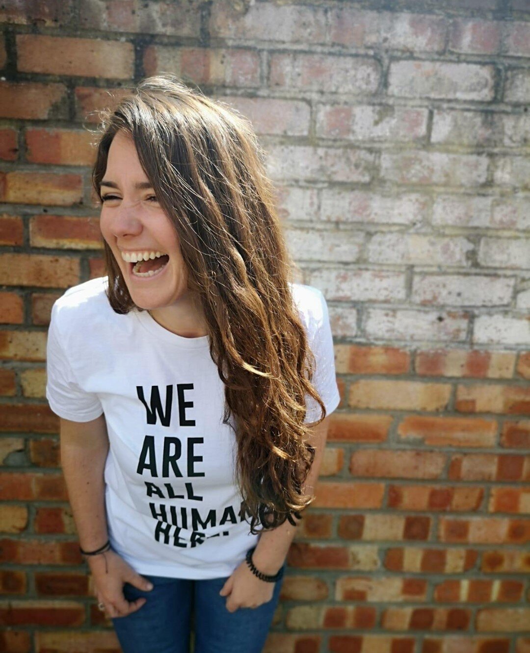 Share a message of positivity this Autumn and feel as awesome as Genevieve here, knowing you&rsquo;re going to look the part in your new &lsquo;We Are All Human Here&rsquo; T. 

Plus, your purchase will go directly towards supporting the vulnerable a