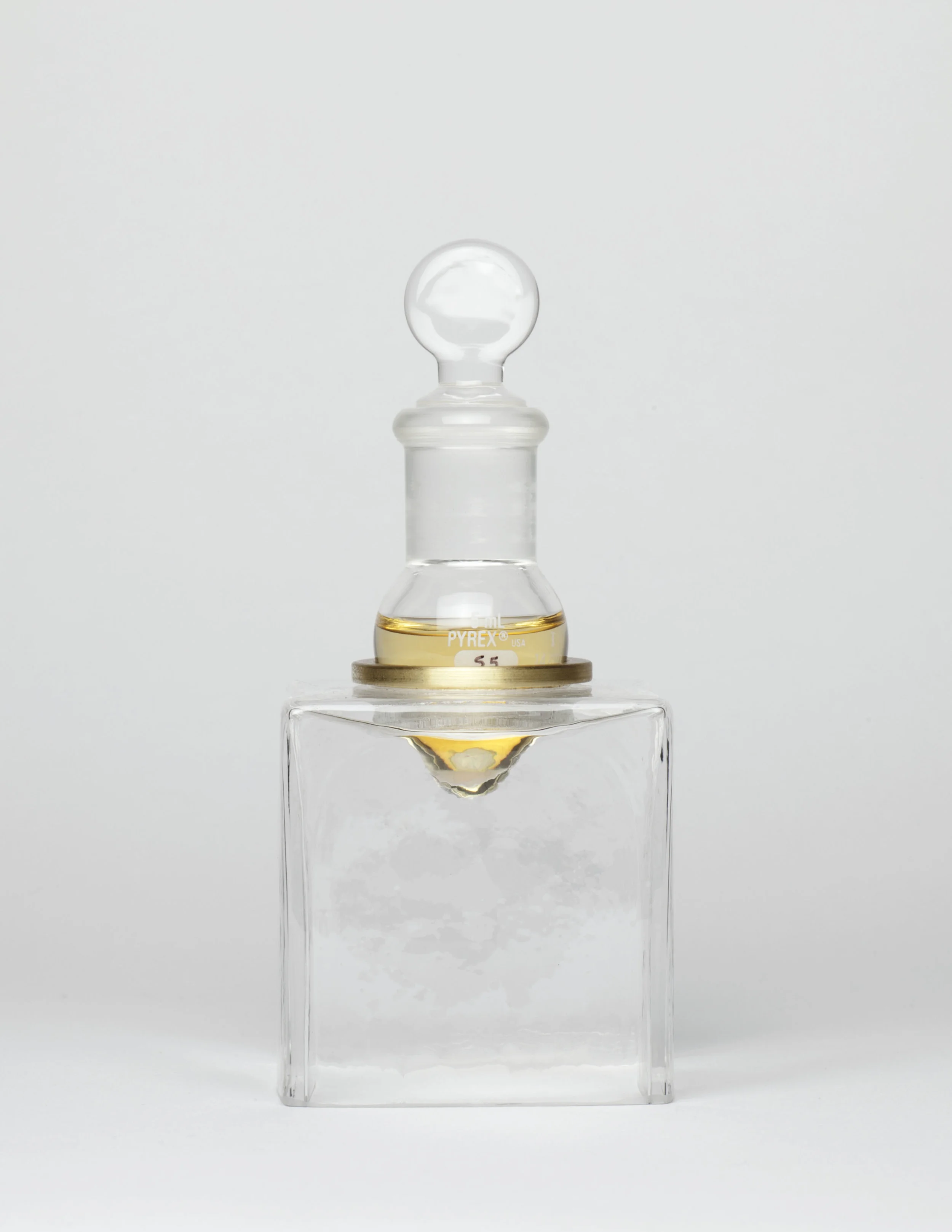 Sweat #5 (S5) . 2011. collected from cotton t-shirt worn to bikram yoga on 08.04.11, (MC 14) sweat essence, glass, brass. 3 x 2 x 2 inches