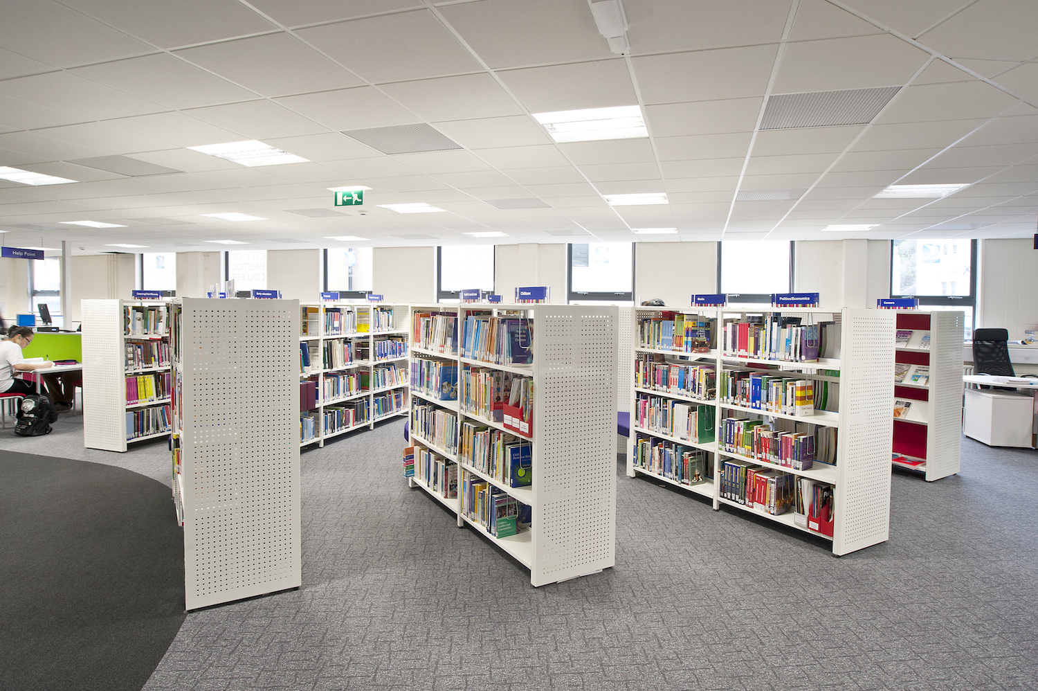 White double sided Aspire shelving with perforated steel end panels 