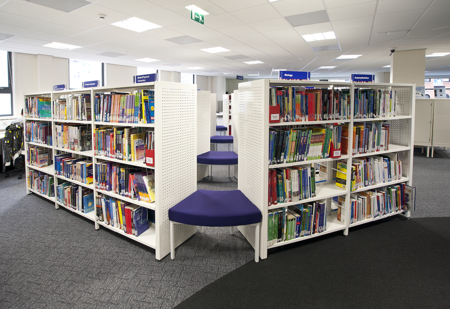 White Aspire shelving separated by seating pads creating alternative display options