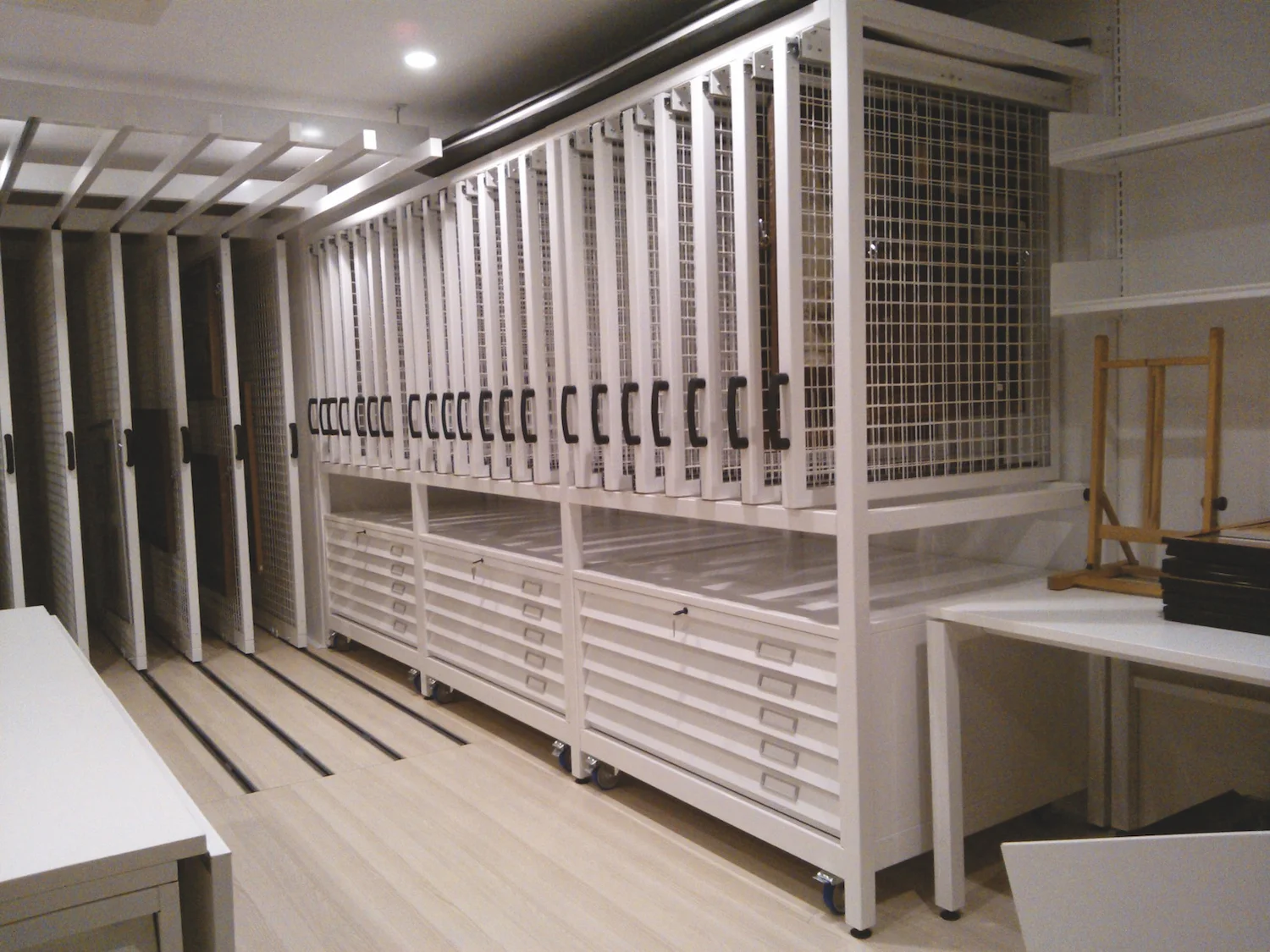 Half height picture racking with moveable plan chest below.