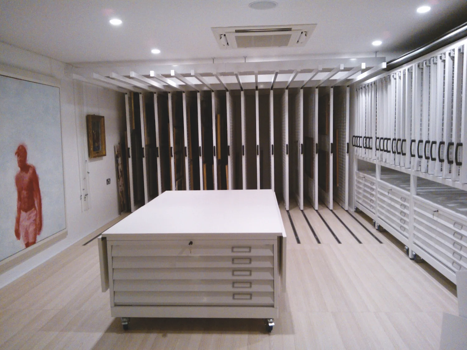 Plan chest topped with a foldable work surface with full height picture racking behind.