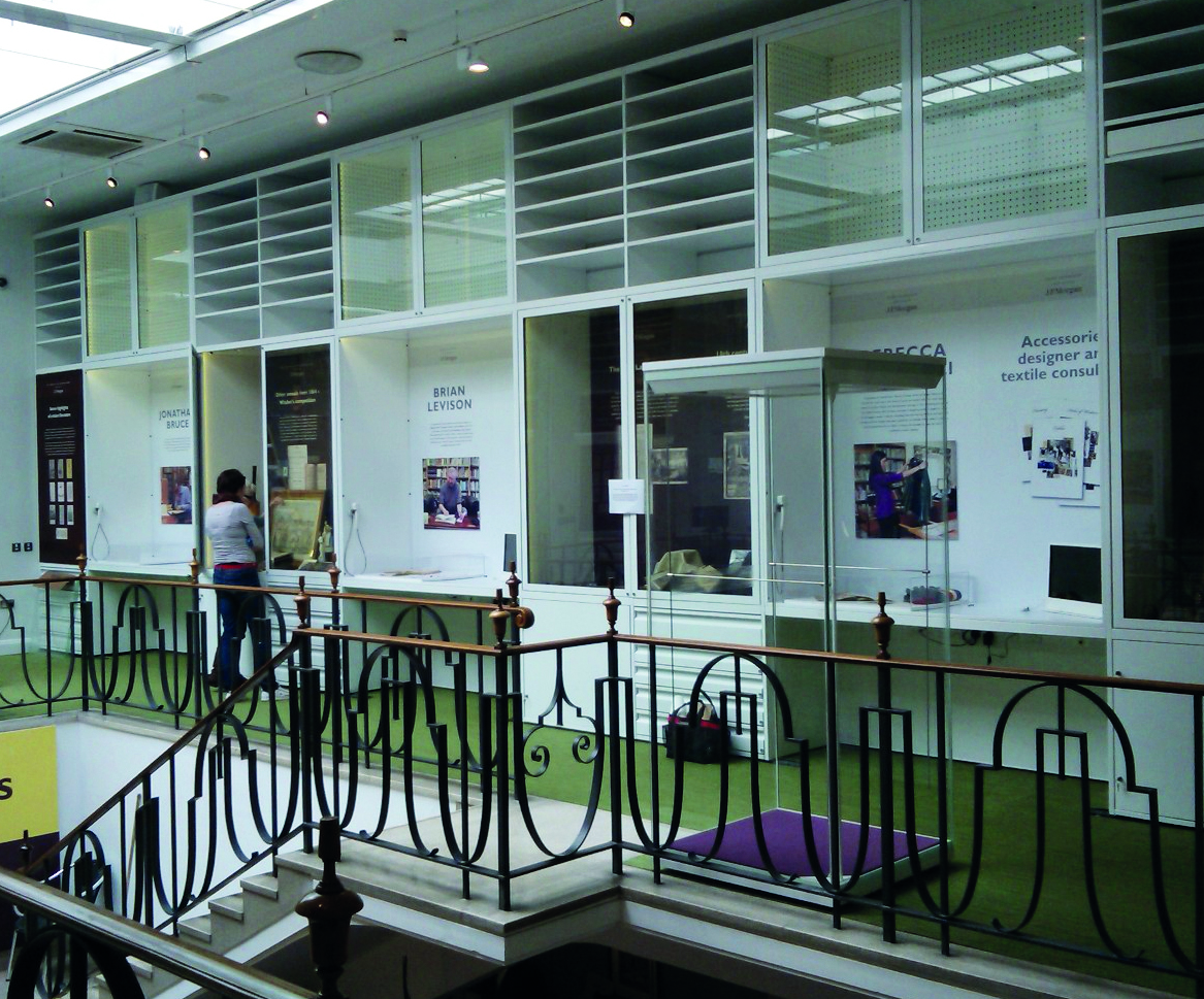 Overall view of upper gallery showing illuminated steel shelving with lockable glazed doors for viewing large format objects.