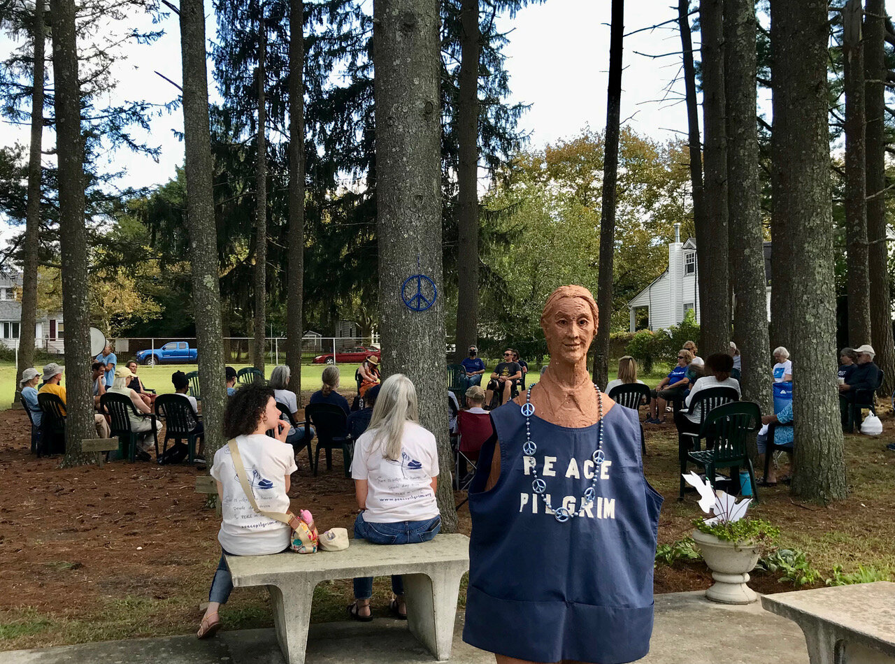  Peace Pilgrim’s statue stands before the beautiful pine grove where participants gathered to celebrate her life.  