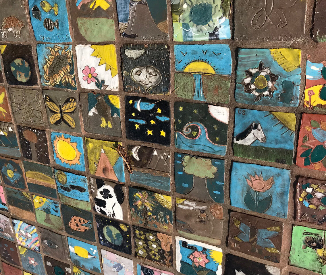 Tiles made by local middle school art students surround peace pilgrim’s statue.  