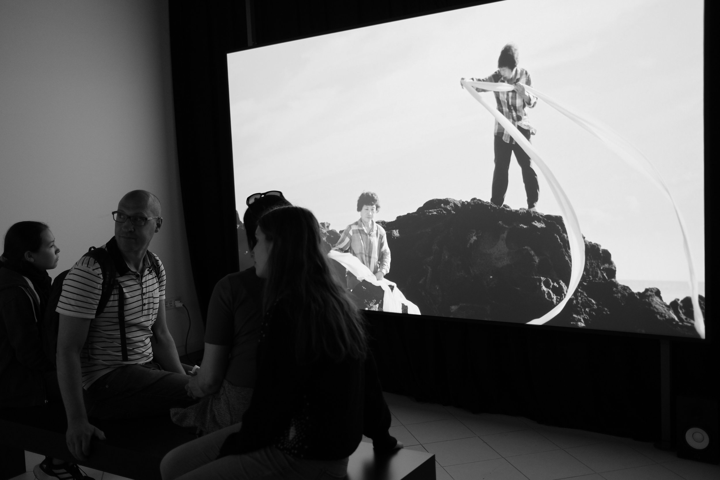 watching Jane Jin Kaisen. i was mesmerized by the gentle, methodological movements of the women on one screen (Halmang, 2023), in seemingly perfect harmony with the playful actions of young children in a burial ground (Guardians, 2024), projected on