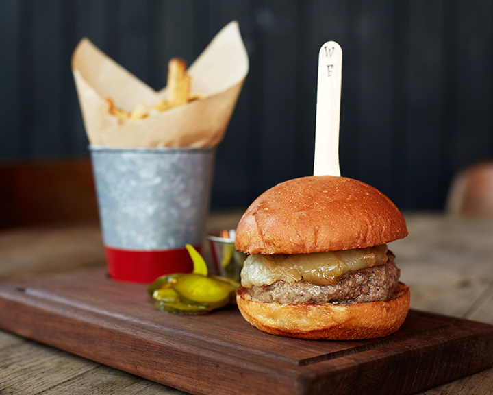 A fan favorite: The Cast Iron Bar Burger. With butter baked onions, tomato relish and hand-cut fries.