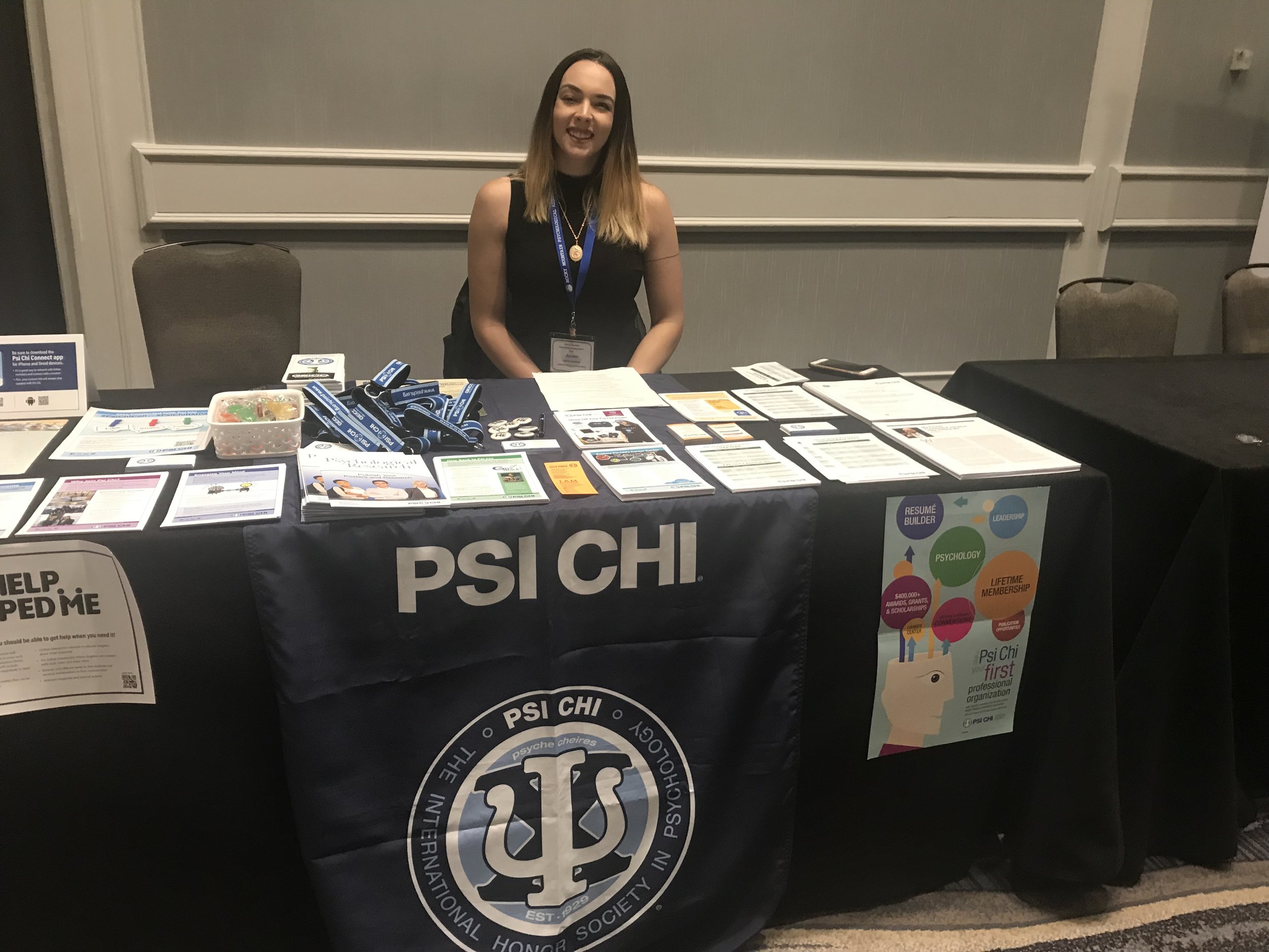 Psi Chi exhibition table with Regional Steering committee student member Keren Bakke.jpg