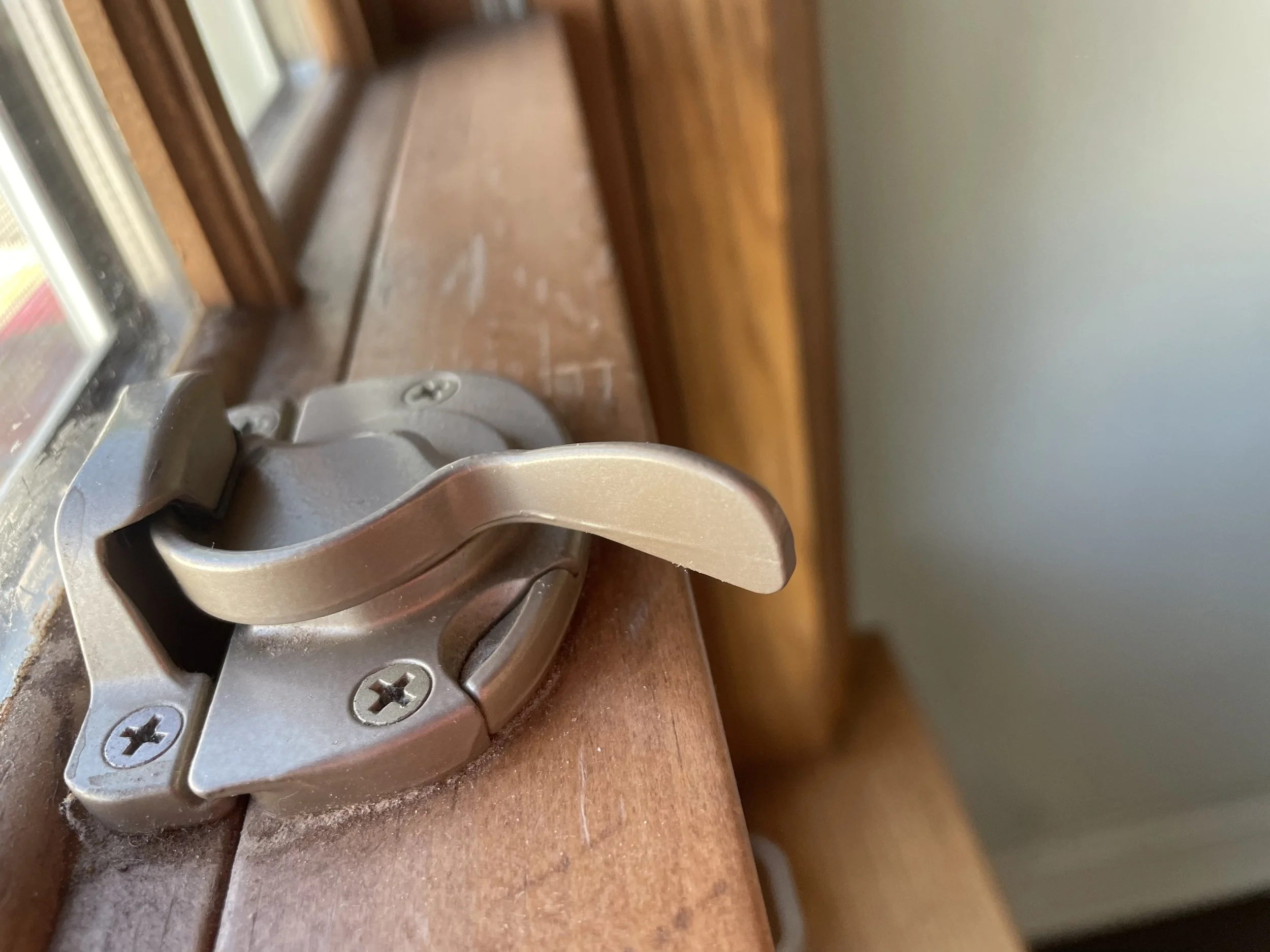 Bronze Sash Lock on a wood double hung window in NYC