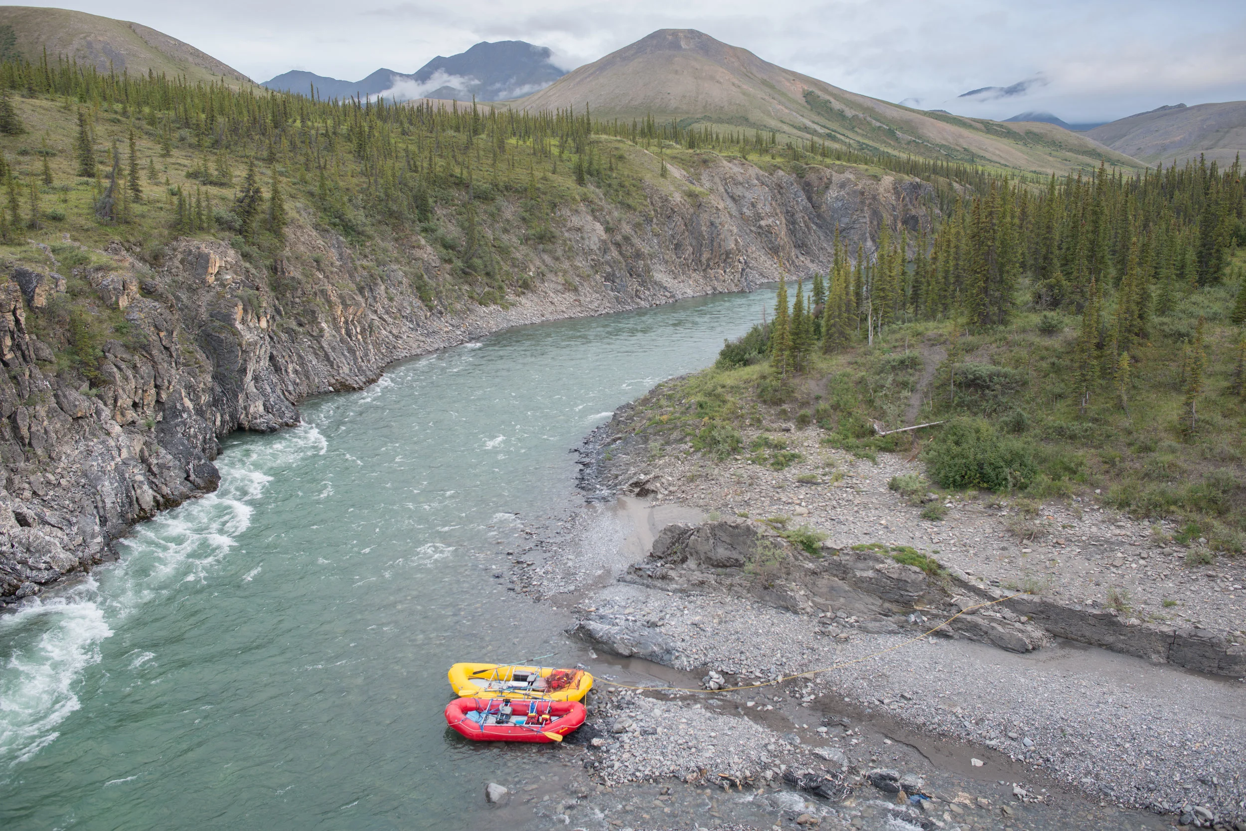A rafting party alight at Sheep Creek
