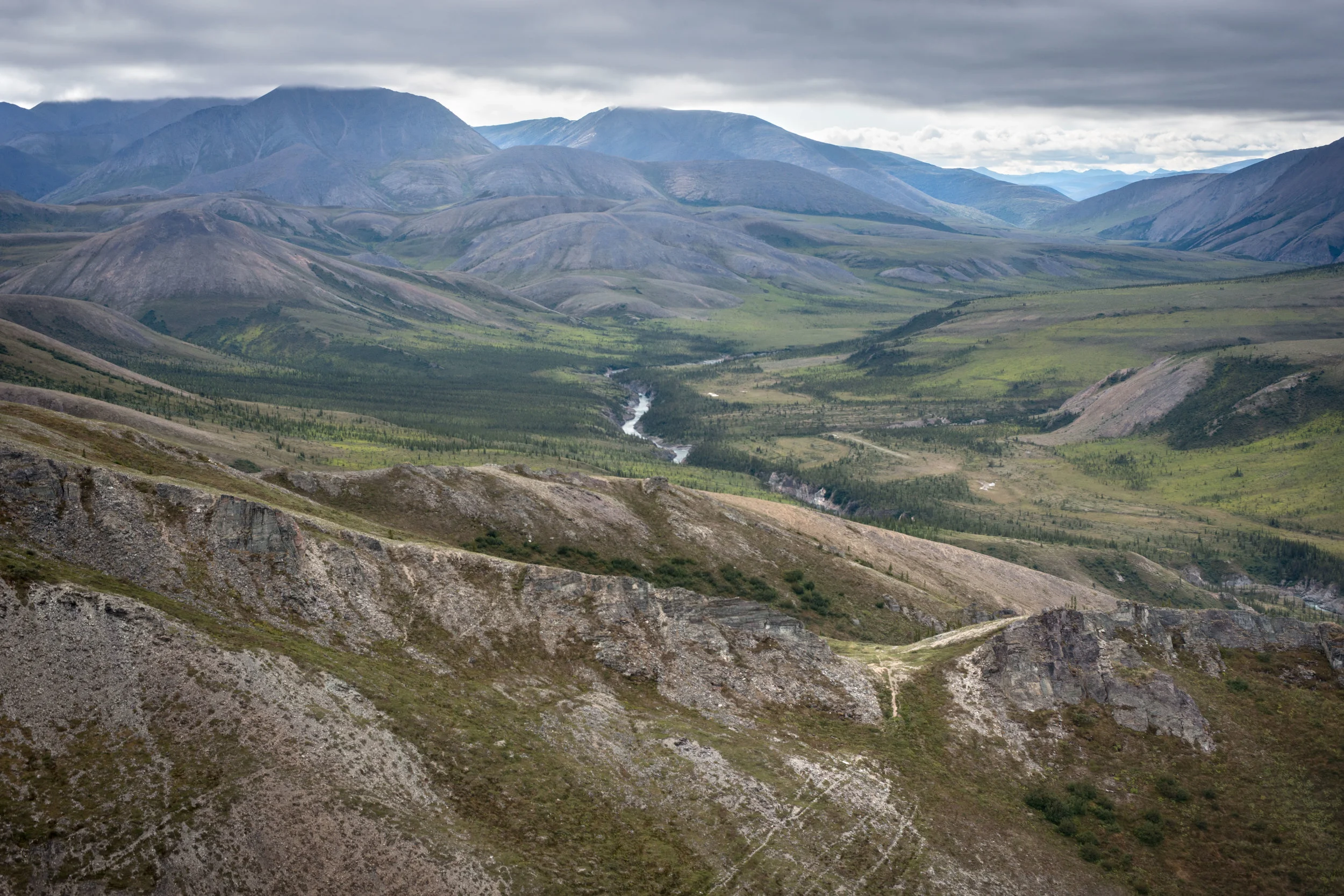 Caribou trails converge on an opening in the ridgeline