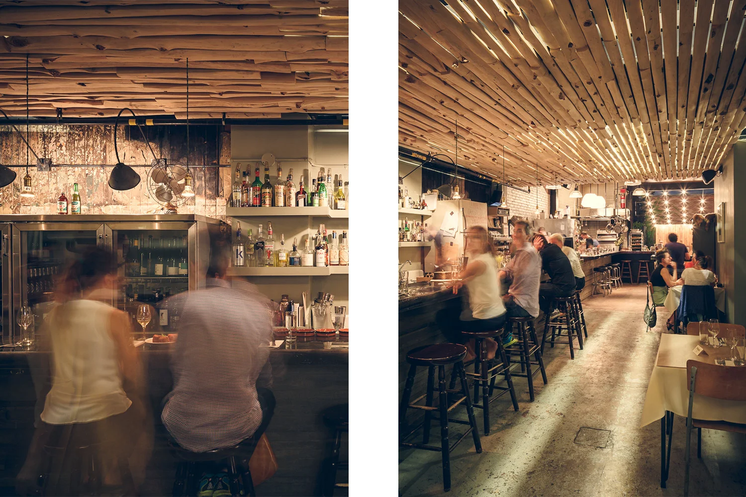 Customers sitting at the bar. The ceiling covered with white cedar without bark shows a shower light. The original walls and concrete floor give an industrial look to the place