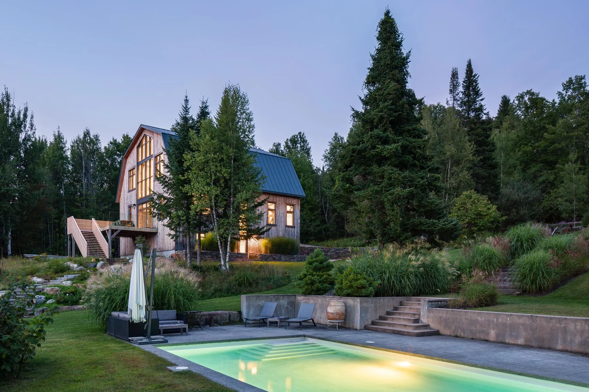 Renovation of a cottage and landscaping. Modern concrete pool. Exterior coating of the barn in boards of cedar board and batten. Large windows and cedar rear terrace