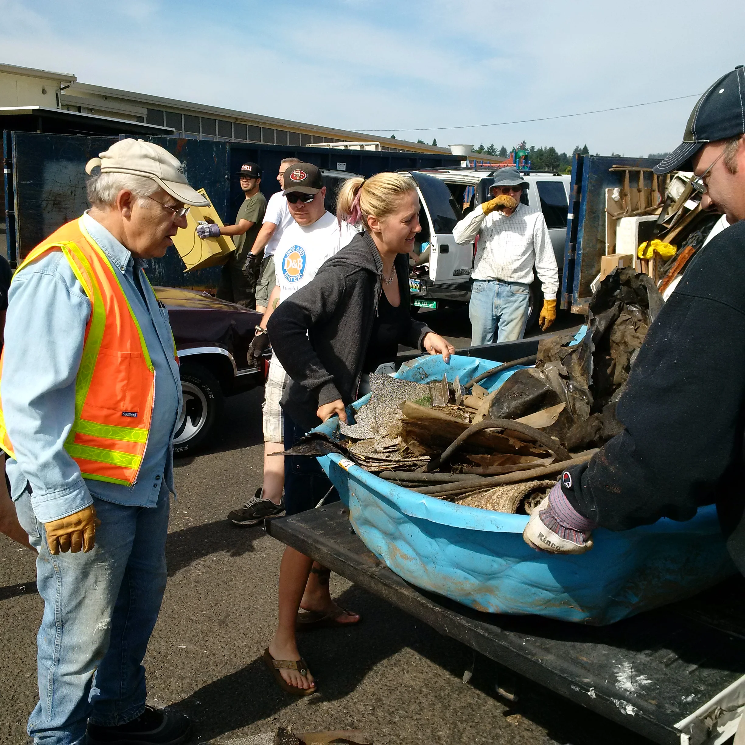 Moving debris at the 2014 Neighborhood Clean Up.Photo by: Mid County Memo