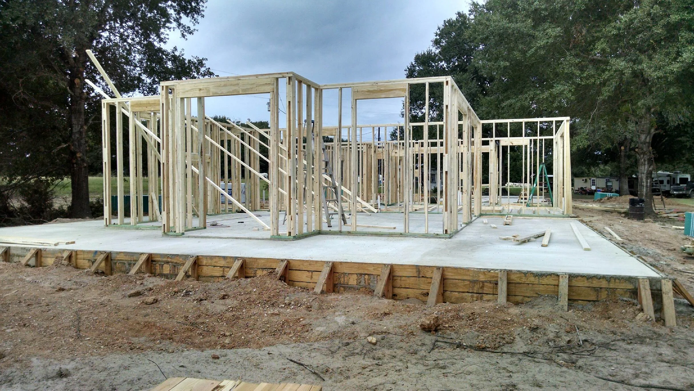 Framing started. Notice the building and trailer in the right back- that's where we lived during construction