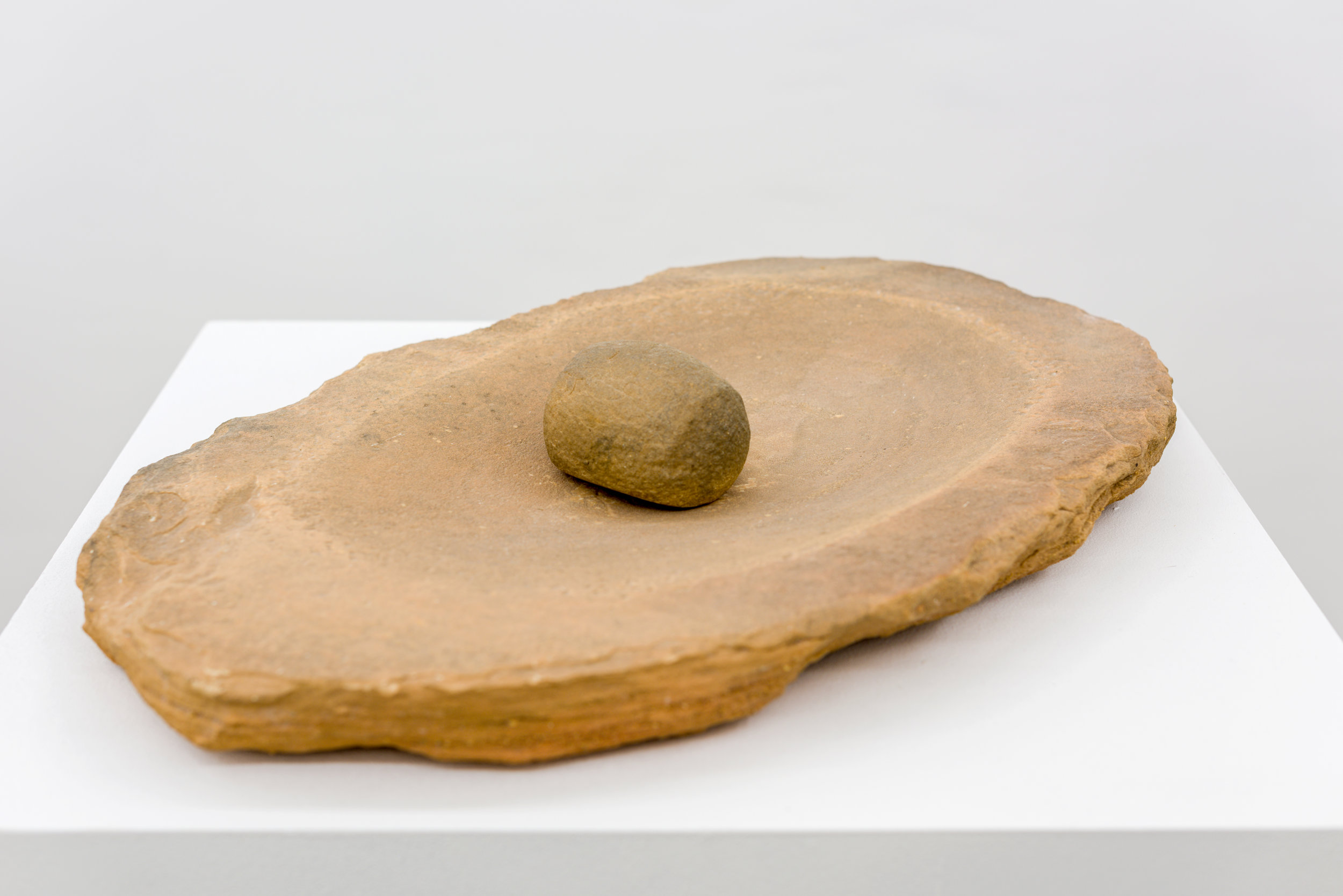   Neolithic Grinding Basin and Pestle ,&nbsp;8th – 7th Millennium B.C.E.,&nbsp;Sandstone,&nbsp;Bowl 62 cm x 40.5 cm / Stone 11 cm x 8 cm,&nbsp;Courtesy Rupert Wace Ancient Art, London 