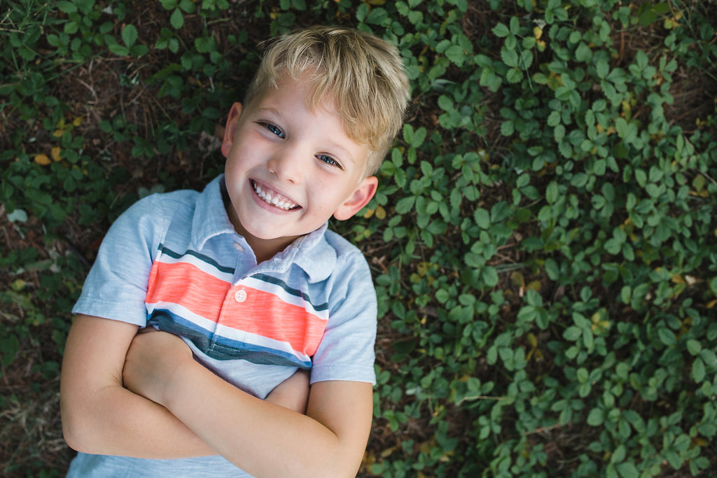 Boy laying in grass Child Photography Rochester Michigan
