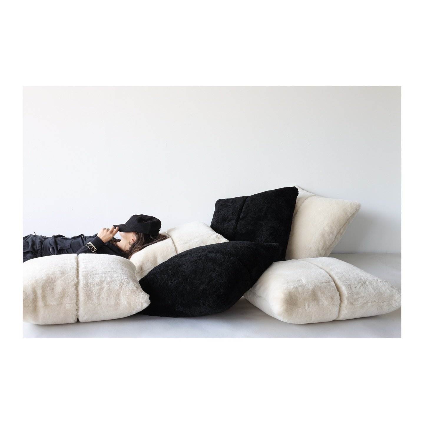 Napping in the clouds. Black and white dreams. @kelacalaq relaxing on our Laced Pillow X in Black and Pearl color Pared Shearling with leather details. @mosesnadel 

#mosesnadel #lacedpillowx #shearling #paredshearling #leather #kelacalaq #madetoorde